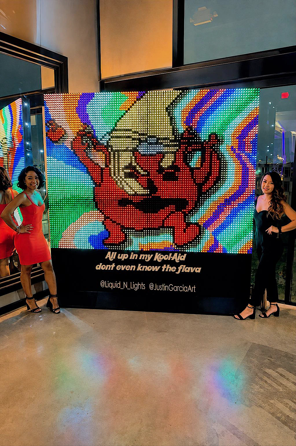 Large custom pop art wall in vivid pink, blue, yellow, and green at an event